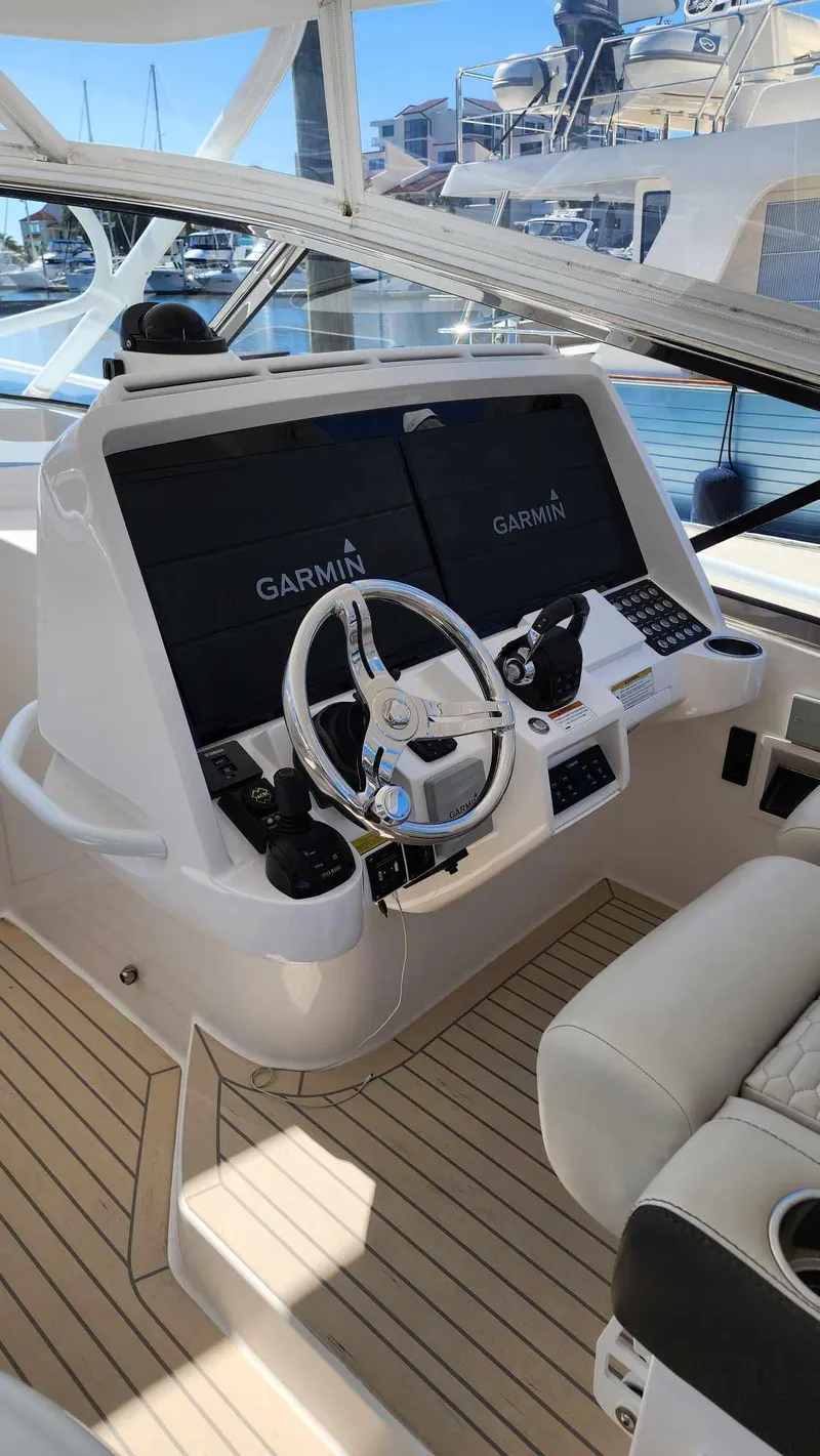Slide: The Image of 2020 Intrepid 475 Sport Yacht helm with Garmin navigation system. - 7