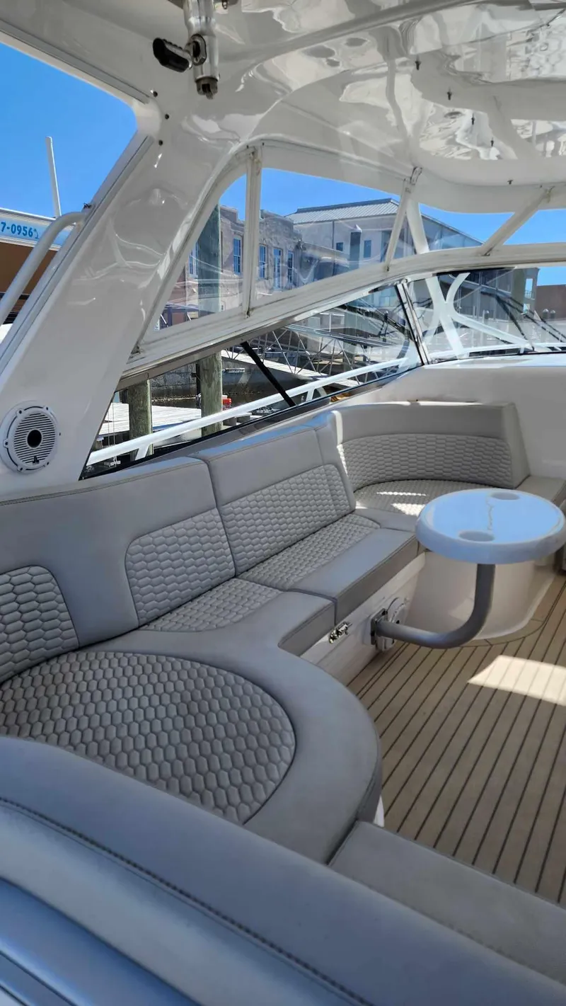 Slide: The Image of Interior of 2020 Intrepid 475 Sport Yacht with luxurious seating and table. - 8