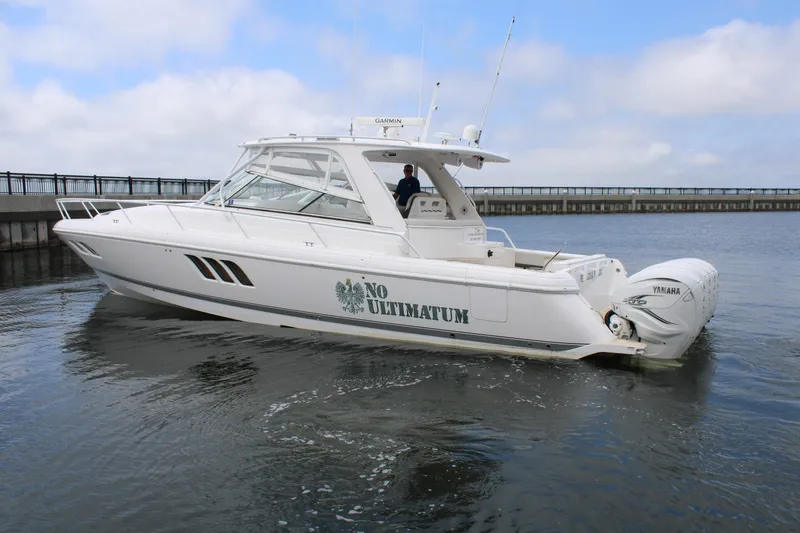 Slide: The Image of 2020 Intrepid 475 Sport Yacht on water, side view, with No Ultimatum text. - 9