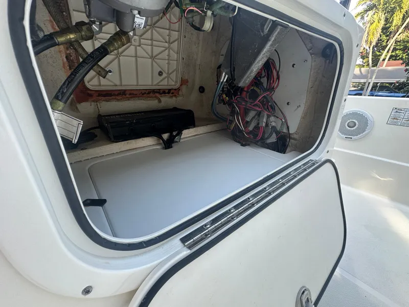 Slide: The Image of Open storage compartment of a 2021 Skeeter SX 2250 boat showing wiring and equipment. - 10