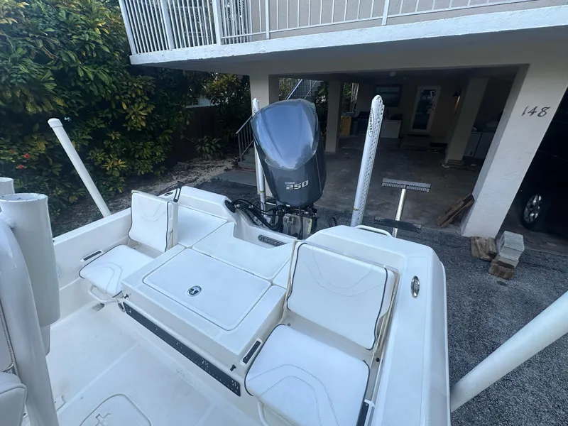 Slide: The Image of 2021 Skeeter SX 2250 boat with outboard motor, parked under a house. - 15