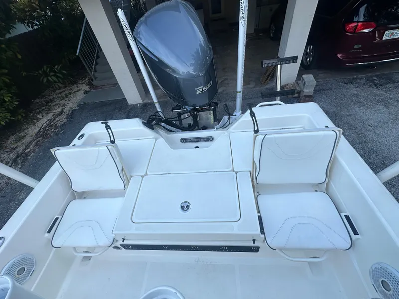 Slide: The Image of 2021 Skeeter SX 2250 boat with Yamaha outboard motor, rear seating, and storage compartments. - 16