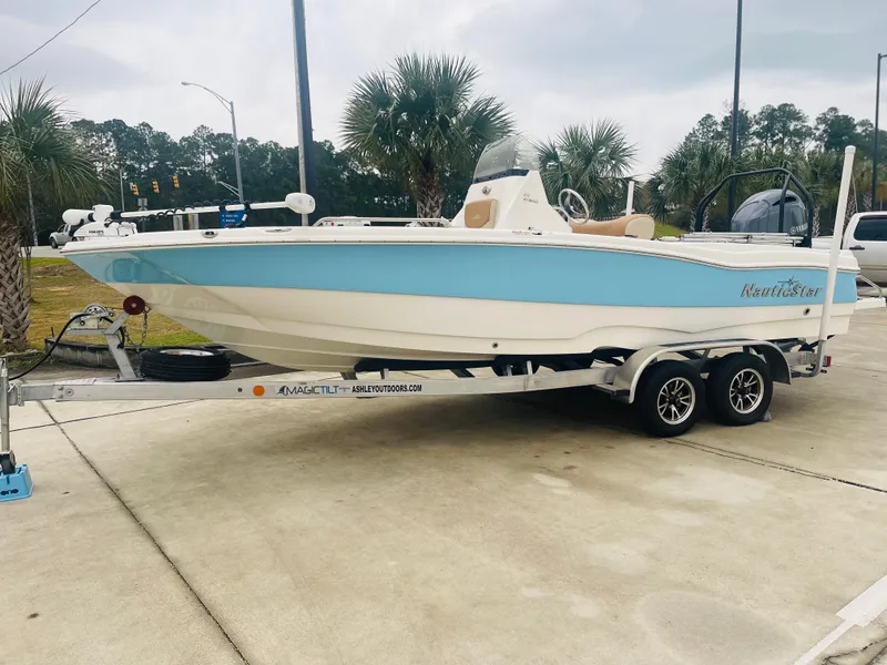The Image of 2023 NauticStar 2110 Nautic Bay boat on a trailer, displayed outdoors. - 1