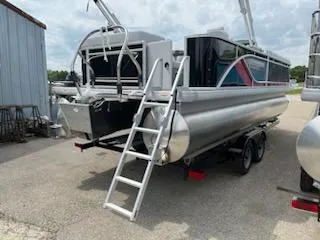 Slide: The Image of 2024 Sweetwater 2286C pontoon boat with ladder and trailer. - 7