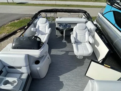 Slide: The Image of 2024 Godfrey 2286SFL pontoon boat with luxurious white seating and modern helm. - 11