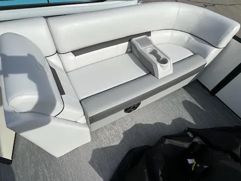 Slide: The Image of 2024 Godfrey 2286sfl boat interior with white cushioned seating and cup holders. - 12