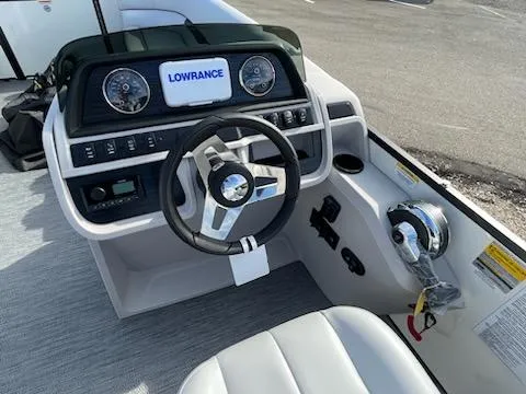 Slide: The Image of 2024 Godfrey 2286sfl boat dashboard with steering wheel and Lowrance display. - 18