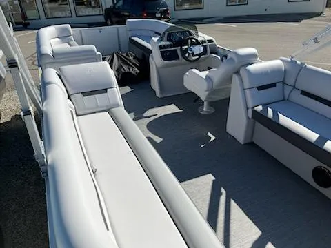 Slide: The Image of 2024 Godfrey 2286SB pontoon boat interior with plush seating and modern helm. - 4