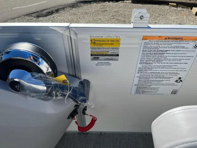 Slide: The Image of 2024 Sweetwater 2286SB boat control panel with capacity and safety warnings. - 9