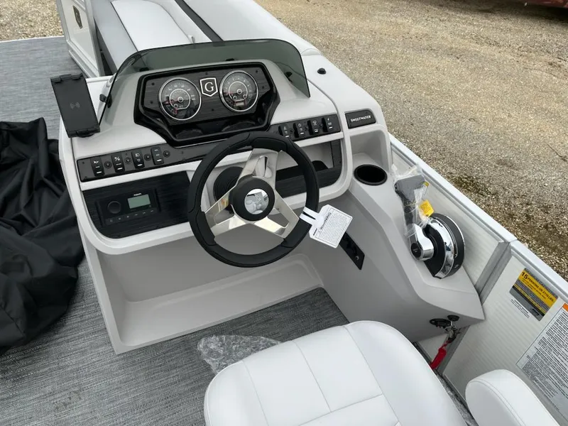 Slide: The Image of 2024 Godfrey 2286SB boat dashboard with steering wheel and control panel. - 11