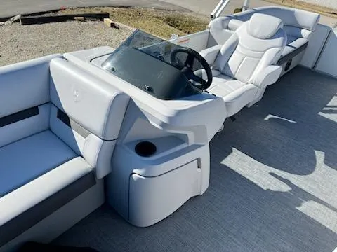 Slide: The Image of 2024 Godfrey 2286SB boat interior with white seating and steering console. - 6