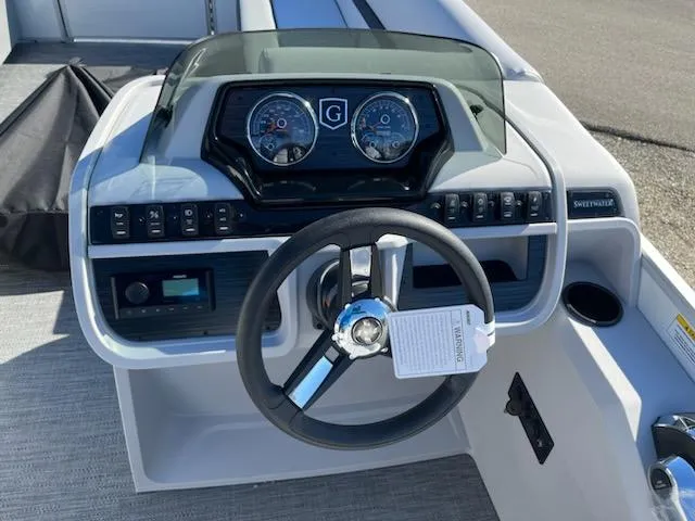 Slide: The Image of 2024 Godfrey 2286SB boat dashboard with steering wheel and instrument panel. - 8