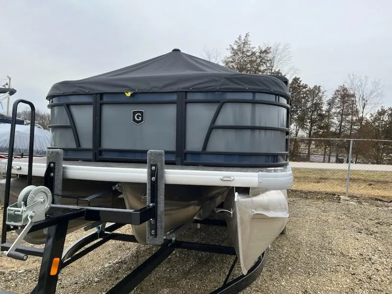 Slide: The Image of 2024 Godfrey 2286sfl pontoon boat with cover, parked on a trailer. - 2