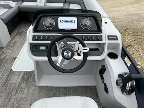 Slide: The Image of 2024 Godfrey 2286sfl boat dashboard with steering wheel, Lowrance display, and control panel. - 6