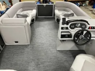 Slide: The Image of 2023 Godfrey 2286SBX pontoon boat interior with gray carpet and plush seating. - 6