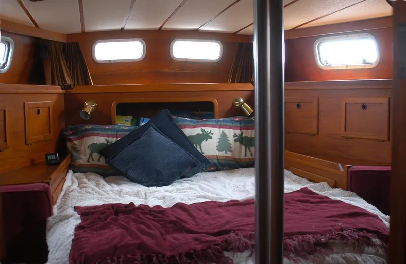 Slide: The Image of Cozy cabin interior of 1985 Nauticat 43 sailboat with wooden finish and bedding. - 10