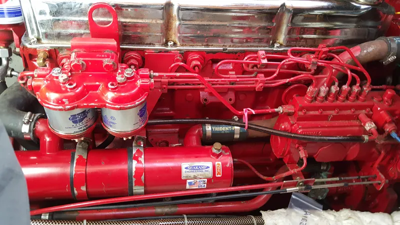 Slide: The Image of Red engine of a 1985 Nauticat 43 boat, showcasing detailed mechanical components. - 12