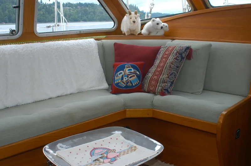 Slide: The Image of Cozy interior of 1985 Nauticat 43 sailboat with plush seating and decorative pillows. - 4