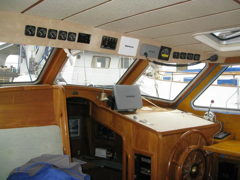 Slide: The Image of Interior view of 1985 Nauticat 43 sailboat cockpit with navigation equipment and wooden finish. - 5