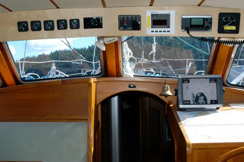 Slide: The Image of Interior view of 1985 Nauticat 43 sailboat cockpit with navigation instruments and wooden finish. - 6