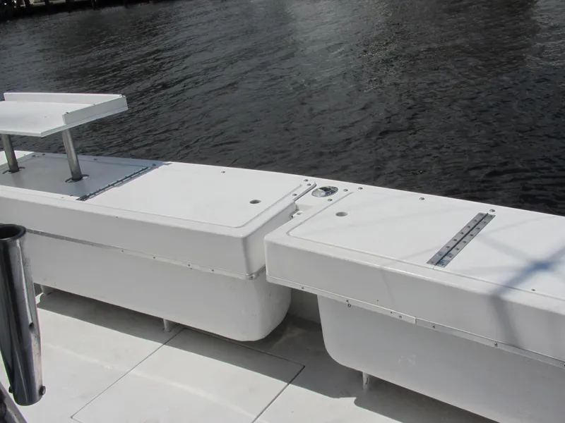 Slide: The Image of 1997 Island Hopper 30 Open boat deck with storage compartments by the water. - 13
