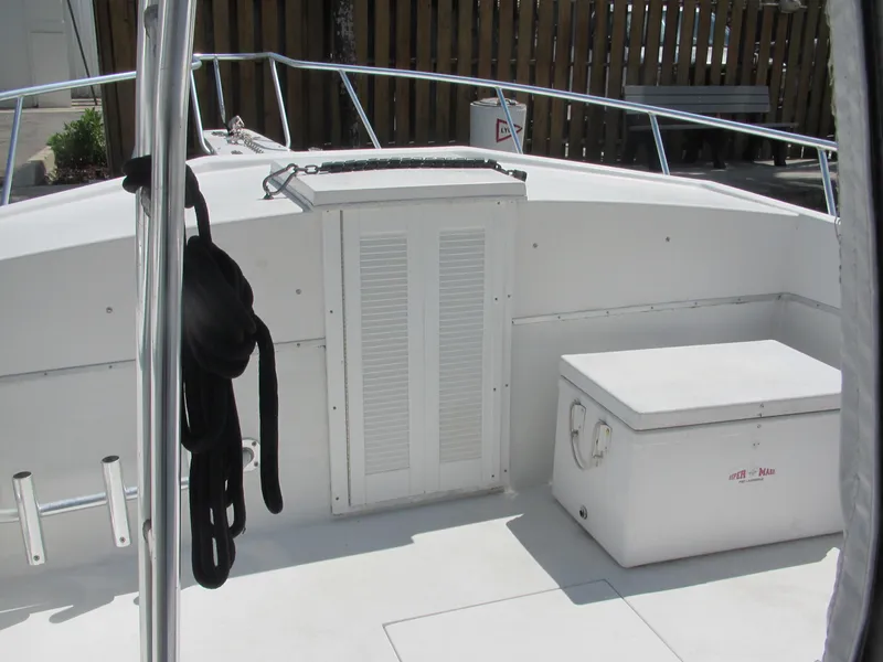 Slide: The Image of 1997 Island Hopper 30 Open boat deck with storage and railing. - 14