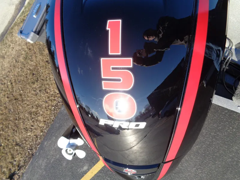 Slide: The Image of 2024 Lund 1875 Fisherman boat engine with "150 Pro" decal, black and red design. - 10