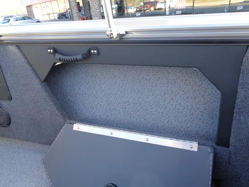 Slide: The Image of 2024 Lund 1875 Fisherman boat interior with storage compartment and handle. - 21