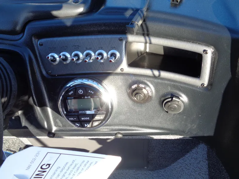 Slide: The Image of 2024 Lund 1875 Fisherman dashboard with controls and switches. - 25