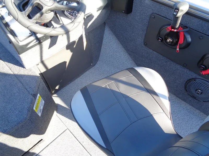 Slide: The Image of 2024 Lund 1875 Fisherman boat interior with steering wheel and seat. - 29