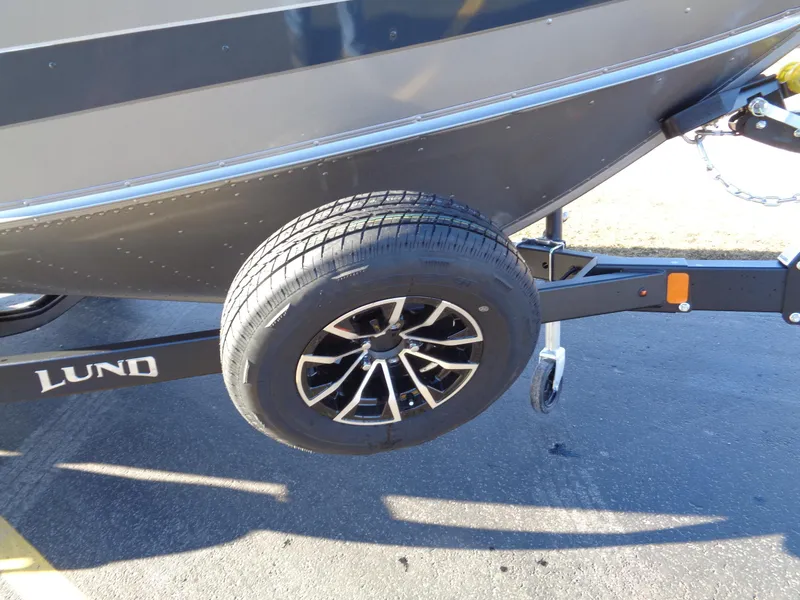 Slide: The Image of 2024 Lund 1875 Fisherman boat trailer with spare tire on asphalt. - 3