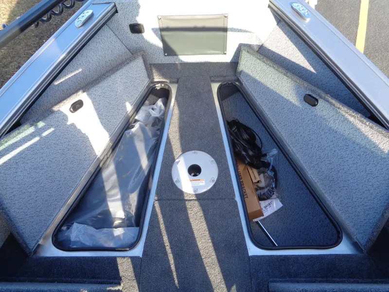 Slide: The Image of 2024 Lund 1875 Fisherman boat interior with open storage compartments. - 37