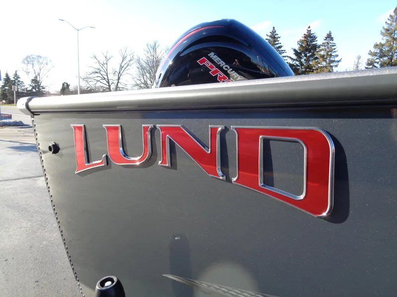 Slide: The Image of 2024 Lund 1875 Fisherman boat with bold red logo and Mercury engine. - 4