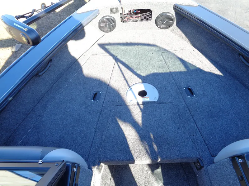 Slide: The Image of 2024 Lund 1875 Fisherman boat interior with carpeted deck and storage compartments. - 47