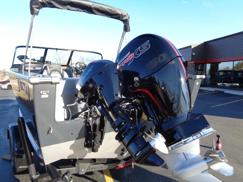 Slide: The Image of 2024 Lund 1875 Fisherman boat with powerful outboard motor in parking lot. - 6