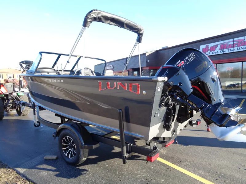 Slide: The Image of 2024 Lund 1875 Fisherman boat on trailer, parked outside dealership. - 7