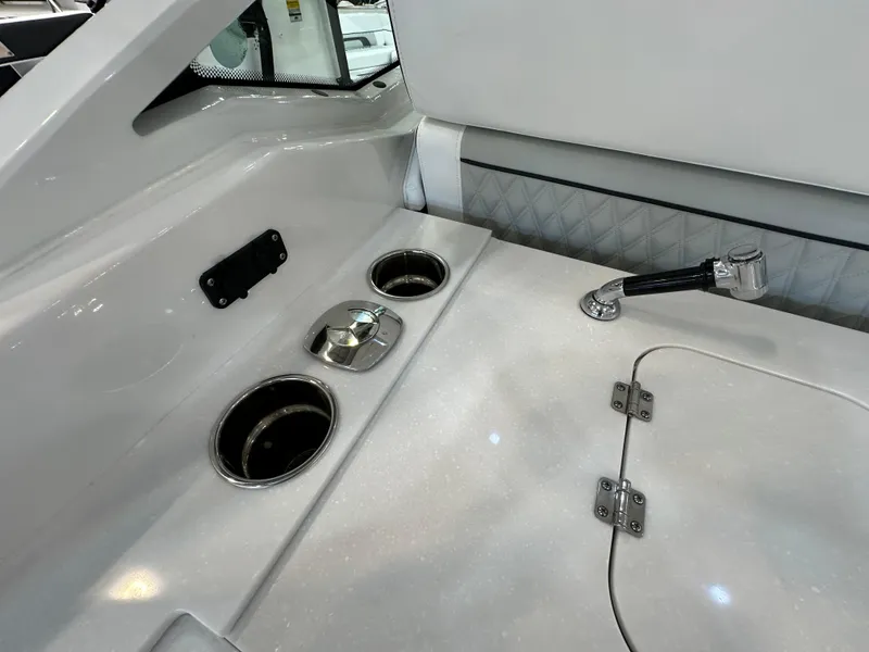 Slide: The Image of 2024 Blackfin 302 DC boat interior with cup holders and storage compartment. - 14