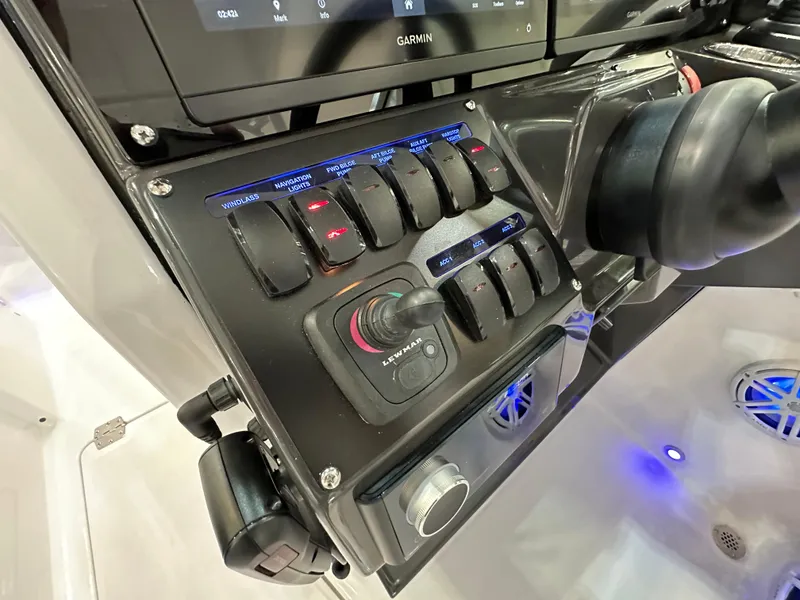 Slide: The Image of Control panel of 2024 Blackfin 302 DC boat with switches and joystick. - 16