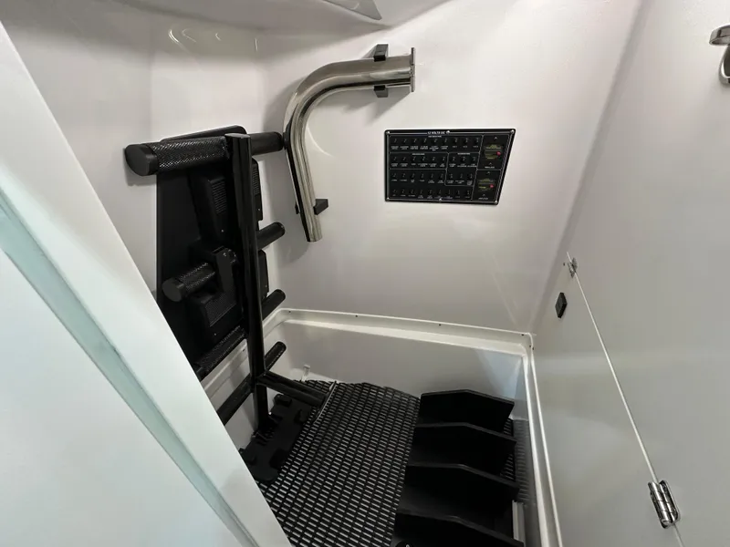 Slide: The Image of 2024 Blackfin 302 DC interior storage compartment with equipment and control panel. - 21