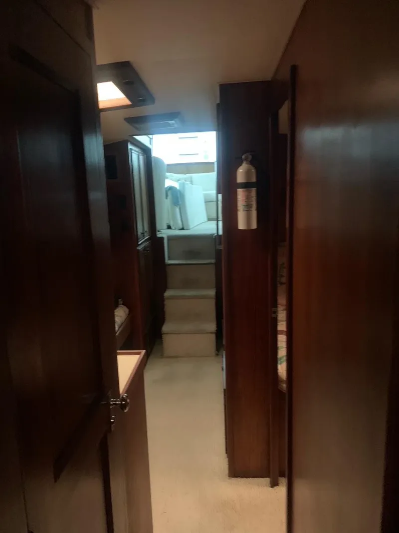Slide: The Image of Interior hallway of 1974 Hatteras 46 Convertible yacht with wooden paneling. - 13