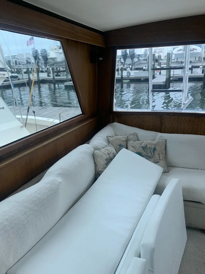 Slide: The Image of Interior of 1974 Hatteras 46 Convertible yacht with marina view through large windows. - 16