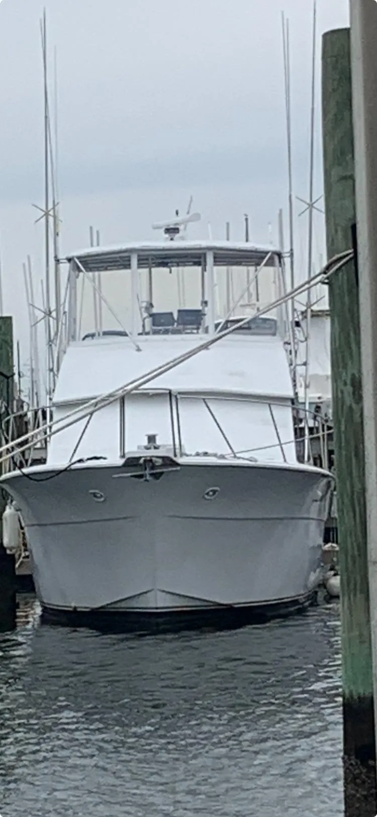 Slide: The Image of 1974 Hatteras 46 Convertible yacht docked at marina. - 2