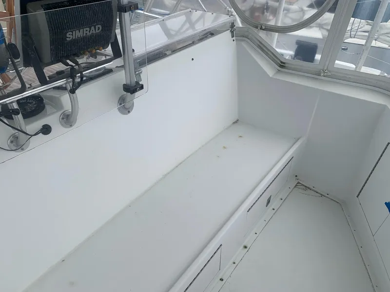 Slide: The Image of 1974 Hatteras 46 Convertible boat interior with Simrad equipment and seating area. - 5