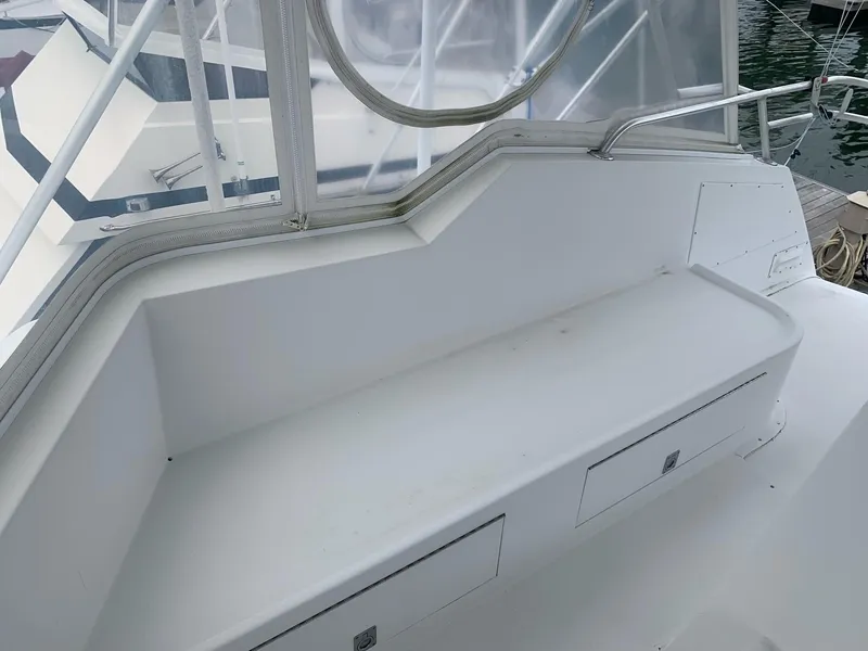 Slide: The Image of 1974 Hatteras 46 Convertible boat interior seating area with storage compartments. - 6