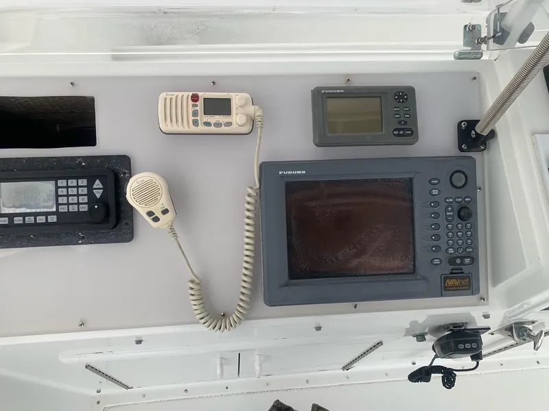 Slide: The Image of 1974 Hatteras 46 Convertible boat dashboard with navigation and communication equipment. - 7