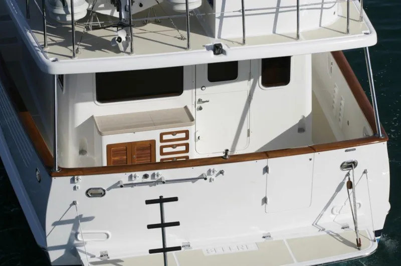 Slide: The Image of Selene 45 Classic Explorer 2026 yacht stern view with wooden accents and ladder. - 10