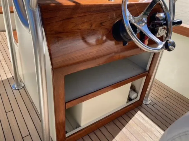 Slide: The Image of 2014 Custom 24' Center Console boat with wooden helm and stainless steel steering wheel. - 16