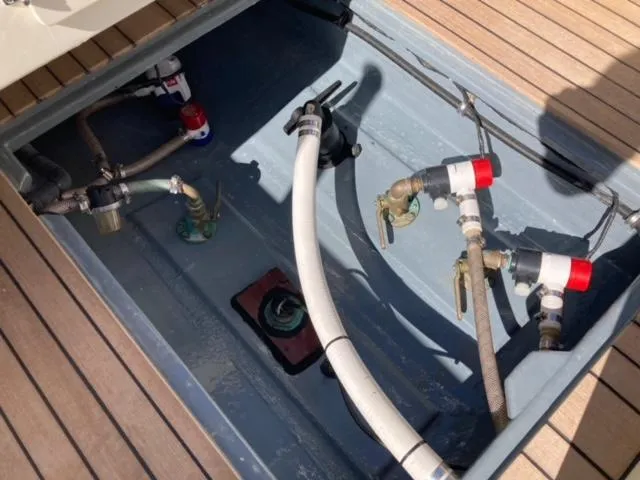 Slide: The Image of 2014 Custom 24' Center Console boat plumbing system with hoses and valves. - 17