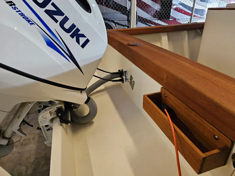 Slide: The Image of 2014 Custom 24' Center Console boat with Suzuki outboard motor detail. - 19