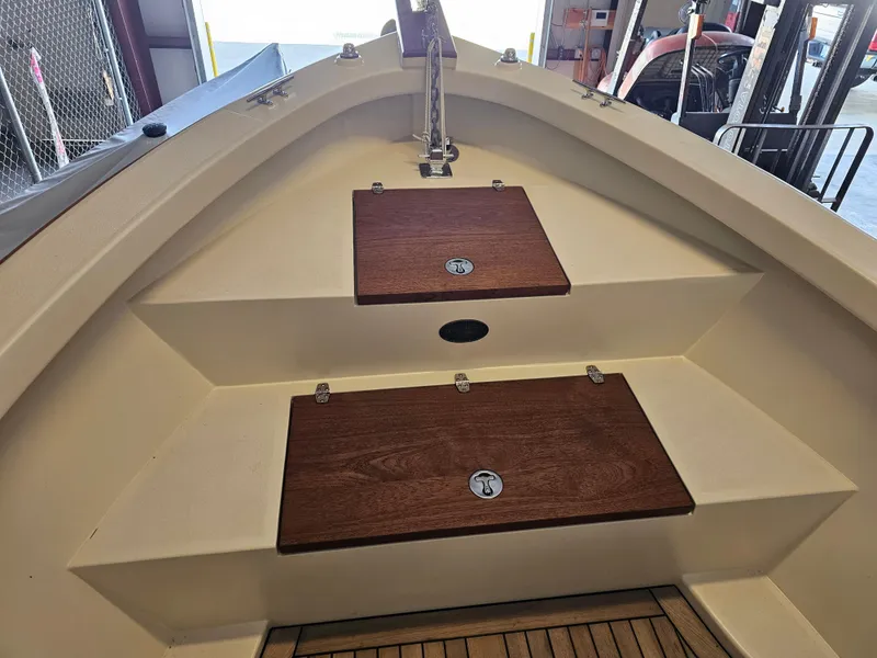 Slide: The Image of 2014 Custom 24' Center Console boat interior with wooden storage compartments. - 20